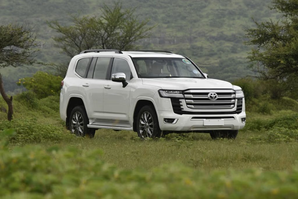 Armoured Land Cruiser parked off-road, bulletproof Revo vs Land Cruiser terrain comparison